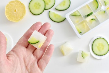 Natural beauty hacks, lemon and cucumber ice cubes for skin brightening.