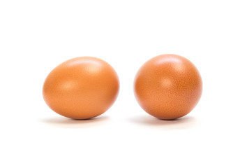 Two orange chicken eggs. Close up. Isolated on white background