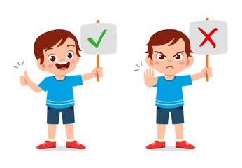 happy cute kid boy with correct and wrong sign