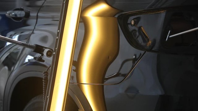 rectification of dents on the metal surface of the car. Metal heating, reflection on the car