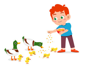 happy cute kid boy feeding cute duck