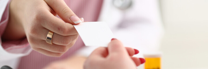 Female physician hand give white blank