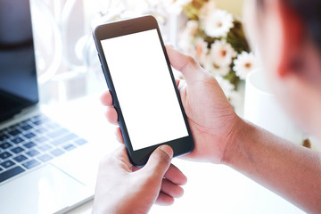 Cropped shot view of man hands holding smart phone with blank copy space screen for your text message or information content, female reading text message on cell telephone during in urban setting. 