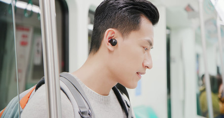 asian man wear wireless earbuds