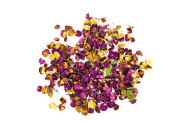 A heap of wilted and dry, red pink and yellow rose petals