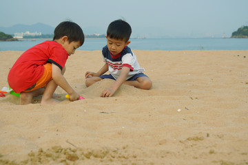 Fototapeta na wymiar Two boys are playing together at the 