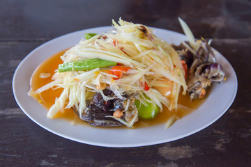 Closeup to Famous Thai food, papaya salad or SOM TAM or Somtum. in white plate.