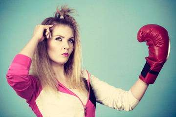 Cute girl in red gloves playing sports boxing