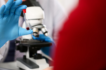 Male hand in blue protective gloves holding
