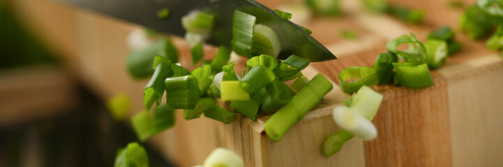 Cook holds knife in hand and cuts on