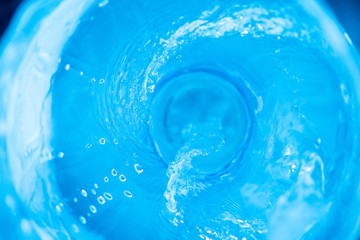 Background with a stream of blue clear water, soft focus