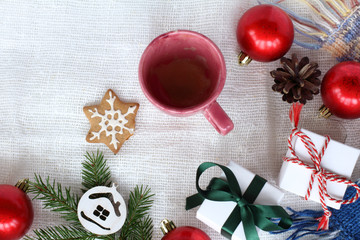 a drunk cup of coffee and a bitten cookie on a table surrounded by decorations top view. delicious warming winter holidays