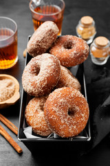 Homemade fresh fried donuts frosted with cinnamon and sugar.