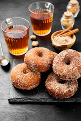 Homemade fresh fried donuts frosted with cinnamon and sugar.