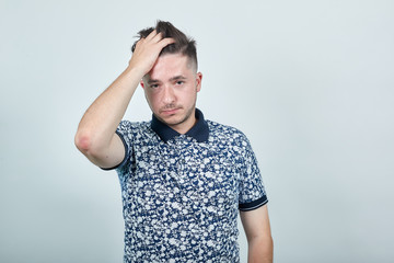 Decent guy in fancy clothes is frustrated and depressed. He is messing with his hairs as he...