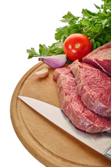raw meat with vegetables and knife
