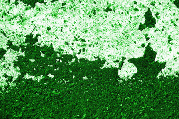 Old asphalt surface with white paint close-up, top view. Abstract background. Green color toned