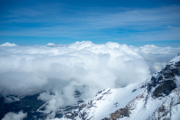 Beautiful scene of clouds and mountains looking from viewpoint at Jungfrau with blue sky for background, copy space, Switzerland