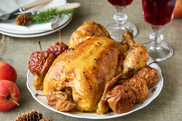 Festive baked chicken with apples on a white dish
