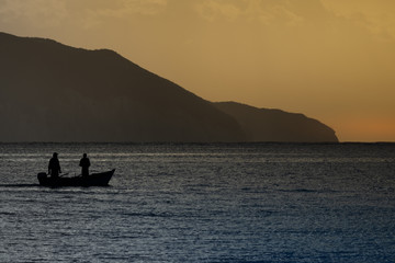 Morning seascape with mountains and fisherman boat