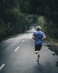 man running on country road