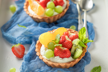 Sweet mini tart made of summer fruits and cream