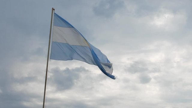 Beautiful Flag of Argentina Waving in the Wind with a Cloudy Background.