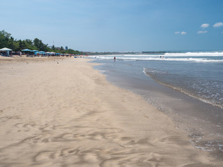 BALI - November 2019: Located on the western side of the island's narrow isthmus, Kuta Beach is Bali's most famous beach resort destination. Autumn in Bali, Indonesia