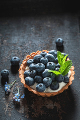 Fresh mini tart with blueberries and whipped cream