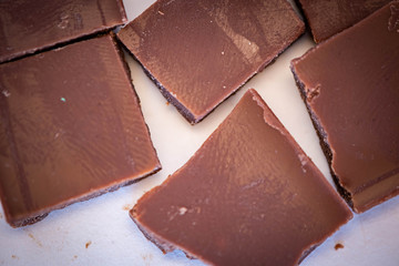 pieces of chocolate on wooden background