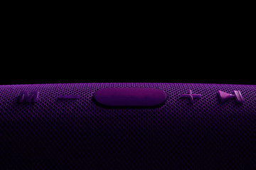 Wireless music column. Purple bluetooth speaker. Control and volume buttons.