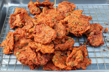 Fried fish cake placed on the grill for sale