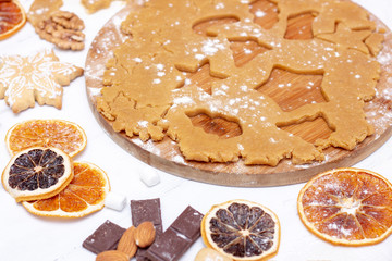 Making christmas gingerbread cookies. Raw dough in shape of gingerbread man,christmas tree, star,
