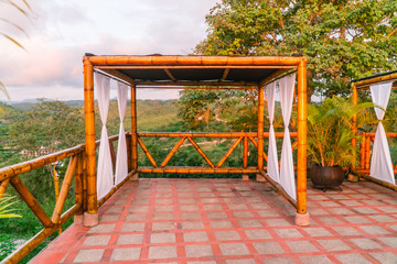 Beautiful natural bamboo cabana hut, used for wedding venue. With white drapes and bamboo wood. Shot on holiday in Montanita, Ecuador.