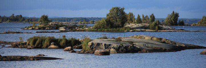 View from a place in Mellerud. Rock formations and small islands covered by trees. Shore of Lake Vanern