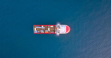 Aerial top view image of an Offshore Supply Ship in the calm ocean water.