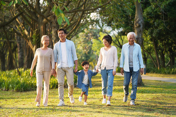 three generation asian family walking in park - obrazy, fototapety, plakaty