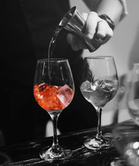 Barman adding the ingredients for the cocktails at the bar