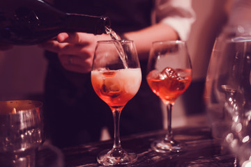 Bartender pouring champagne into glass,