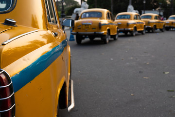 Local yellow taxi waiting for passengers in taxi stand near Victoria Memorial. Yellow taxi is...