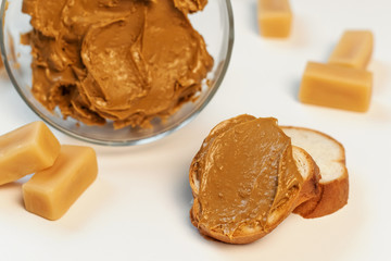 Sweet cream in glass bowl. Confectionery, sweet life, calories. Brown iris cream.