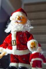 Toy Santa Claus. Santa Claus close-up, on a dark background. Festive man in a red suit and with a beard