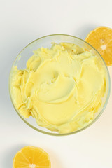 Naklejka na ściany i meble Sweet cream in glass bowl. Lemon sweet yellow cream. Confectionery, sweet life, calories.
