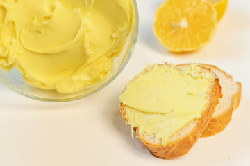 Sweet cream in glass bowl. Lemon sweet yellow cream. Confectionery, sweet life, calories.