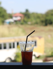 Black coffee with ice on table in cafe.