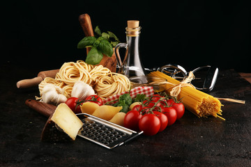 Pasta, vegetables, herbs and spices for Italian food on rustic table