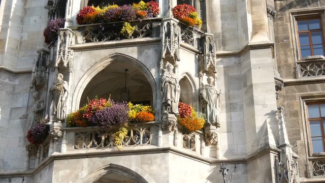 Munich, Germany - October 25, 2019: Part of the new town hall in Munich is decorated with a variety of blooming flowers. Marienplatz, the central square of the city