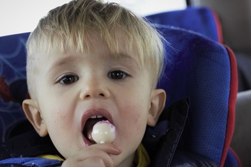portrait of a boy eating lolypop
