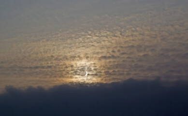 Obraz na płótnie Canvas Partial sun eclipse in a stormy sky