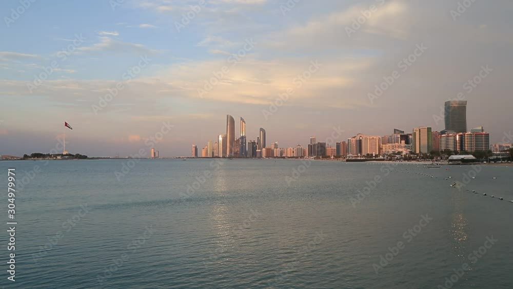 Wall mural Abu Dhabi skyline at sunset. Establishing shot.